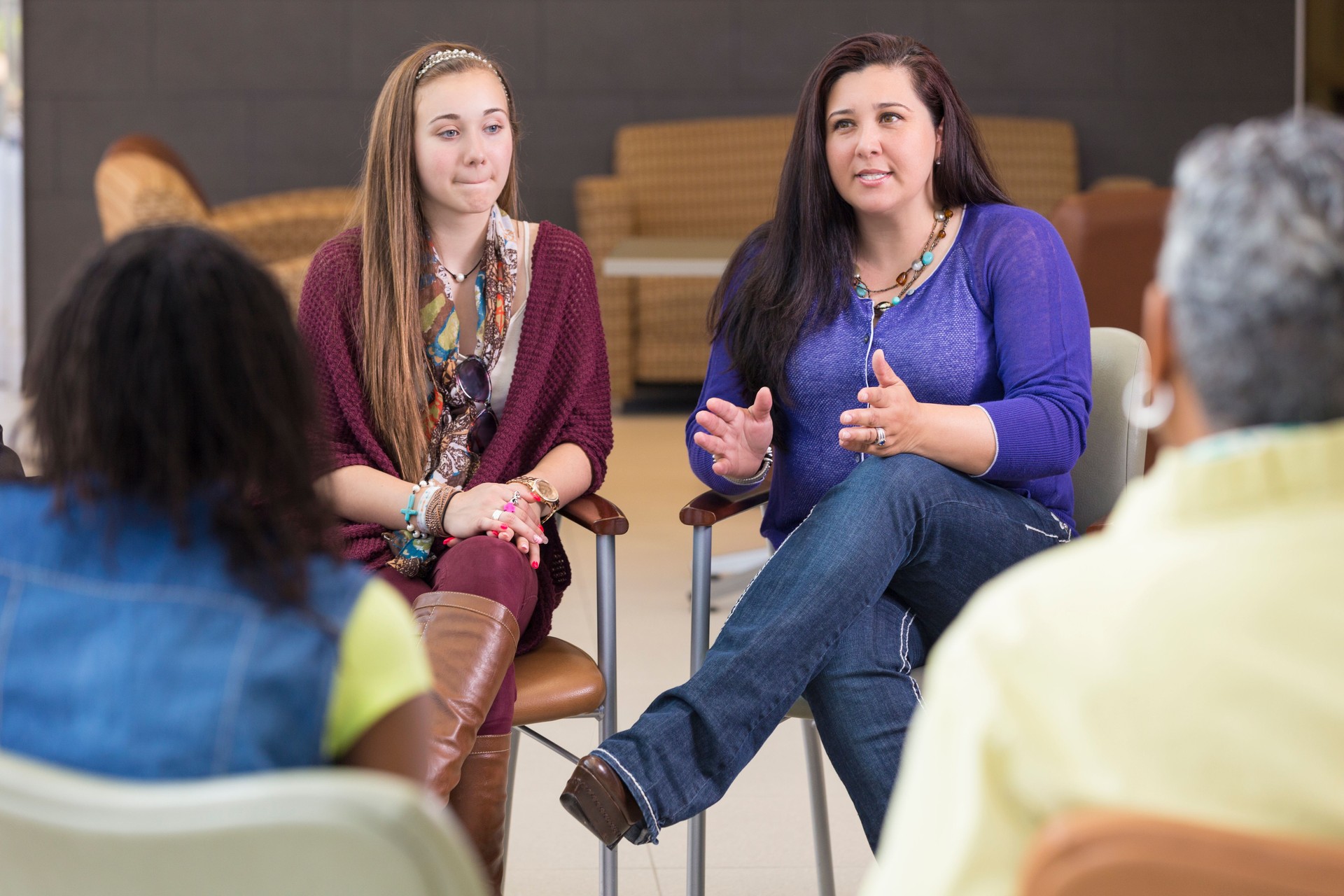 Mother talking about parenting relationship in support group meeting